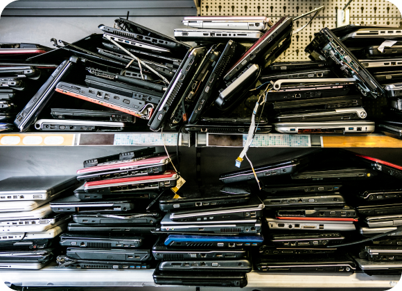 Assorted laptops neatly arranged on a shelf