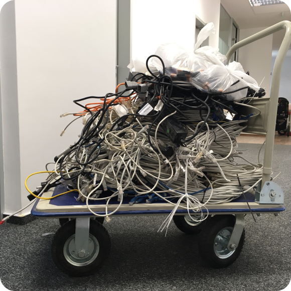 Several computer cords neatly organized on a dolly