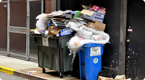 Two dumpsters overflowing with trash