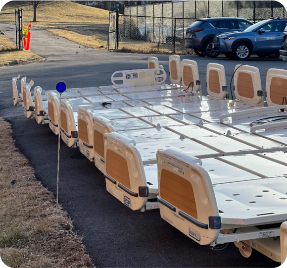 Row of broken hospital beds removed from a hospital for recycling